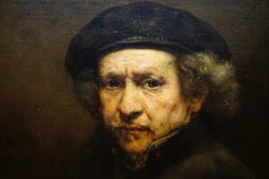 autorretrato de pintor famoso Rembrandt Smithsonian National Gallery of Art. Homem de meia-idade de chapéu olhando para o observador
